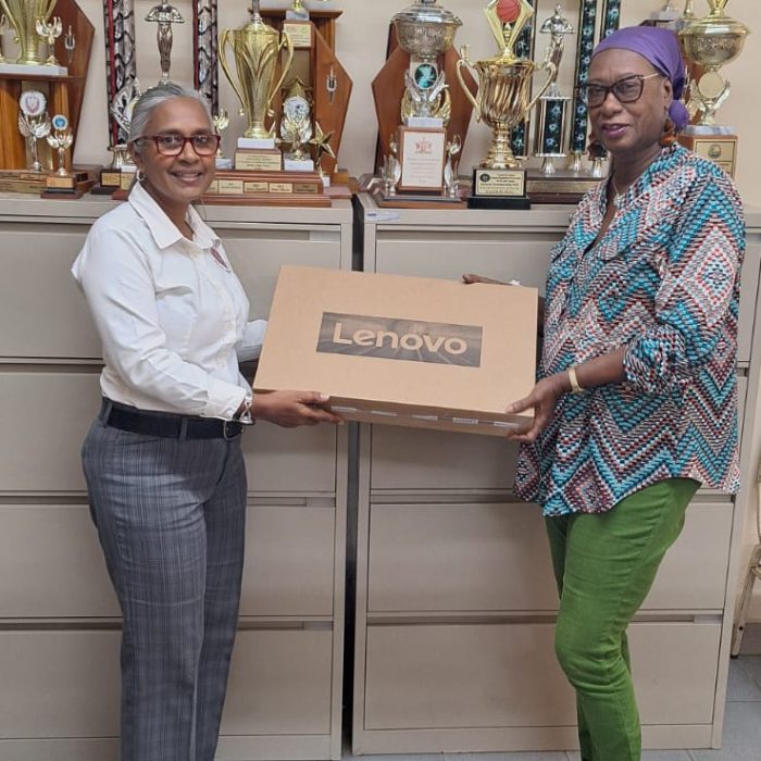 Bhs Principal gifts CentennialCommittee with a computer